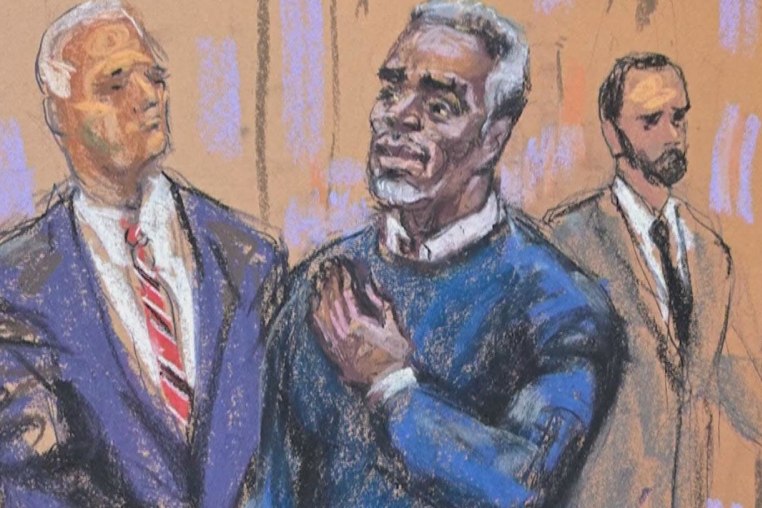 Sean "Diddy" Combs puts his hand on his heart as he enters the courtroom for jury selection at the start of his sex trafficking trial in New York on May 6, 2025.