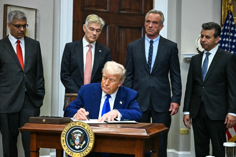 Image: President Donald Trump signs an executive order on prescription drug prices