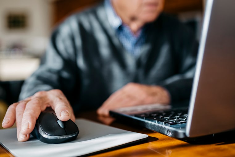 Hand of senior man using mouse, close-up.