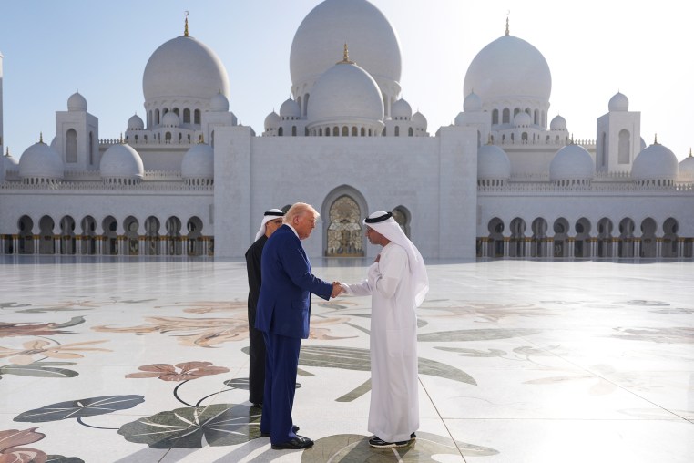 President Donald Trump shakes hands with with Yousif Al Obaidli