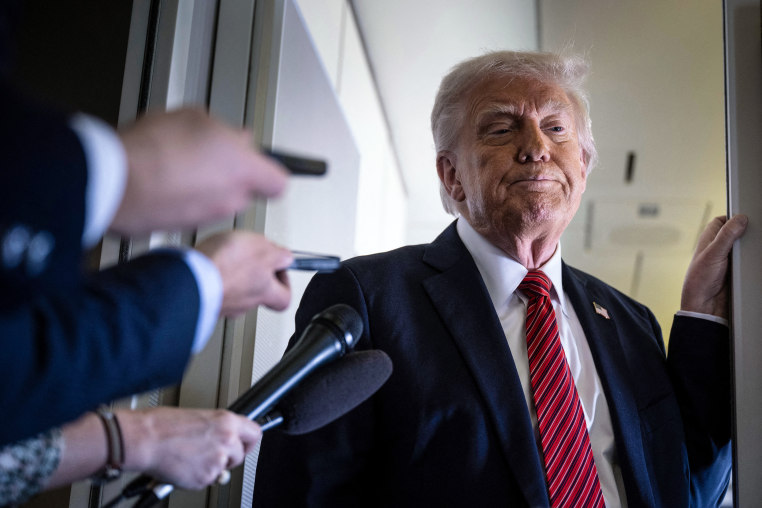 President Donald Trump listens to questions 