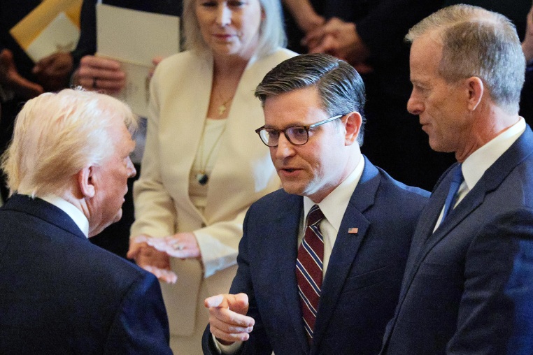President Donald Trump shakes hands with House Speaker Rep. Mike Johnson and Senate Majority Leader John Thune (R-SD)