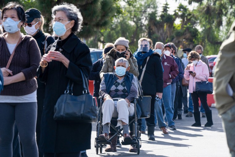 People wait in line to get the vaccine.
