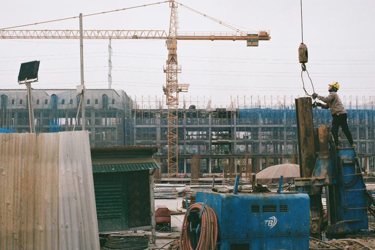 New houses under construction north of Hanoi's West Lake. Vietnam's GDP has averaged 5-7%  annual growth, far outpacing China and America, fueled in part by a relentless construction boom.