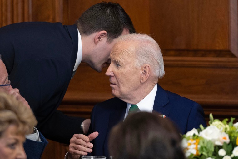 Jacob Spreyer, personal aide, speaks to the president during the annual Friends Of Ireland Speaker Luncheon at the Capitol on March 15, 2023.