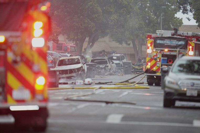 Authorities work the scene where a small plane crashed into a San Diego neighborhood early Thursday, May 22, 2025. 