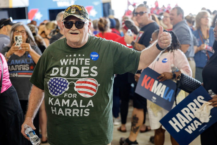 A supporter wears a "White Dudes for Kamala Harris" shirt