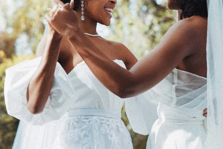 black lesbian couple dancing during wedding.