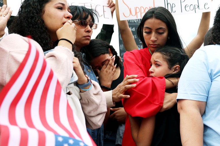 Family members cry during a protest