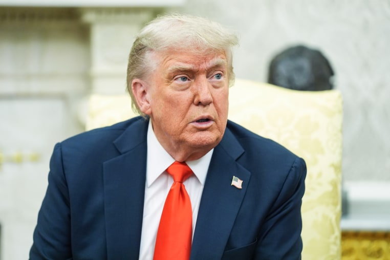 Donald Trump speaks while seated