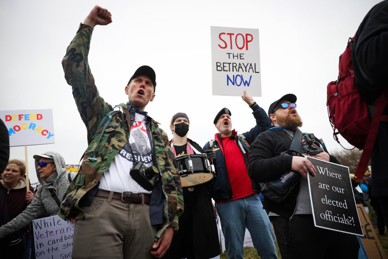 Protesters shout during a "Veterans March" at the National Mall on March 14, 2025.