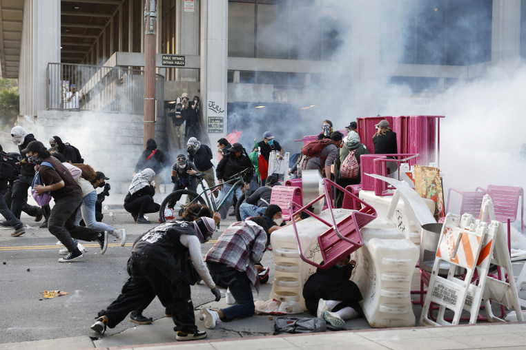Police fire tear gas and break through a barricade