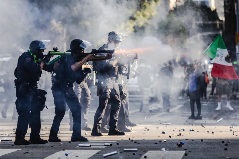 Police shoot projectiles outside on the street