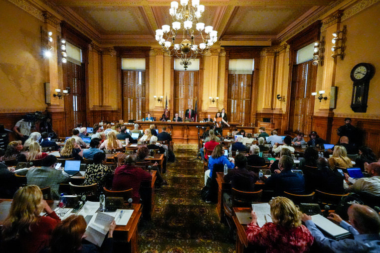 Georgia's State Election Board members discuss proposals to a full room for election rule changes at the state capitol on Sept. 20, 2024, in Atlanta.