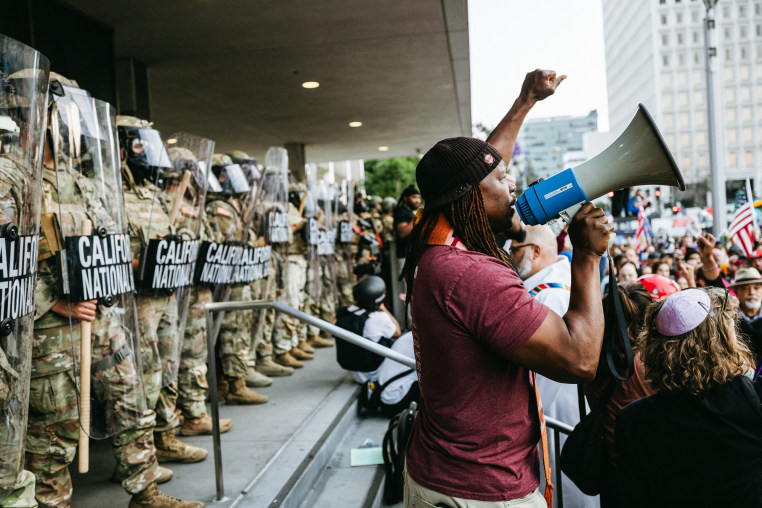 Protestors demonstrate in front of a row of National Guard members outside