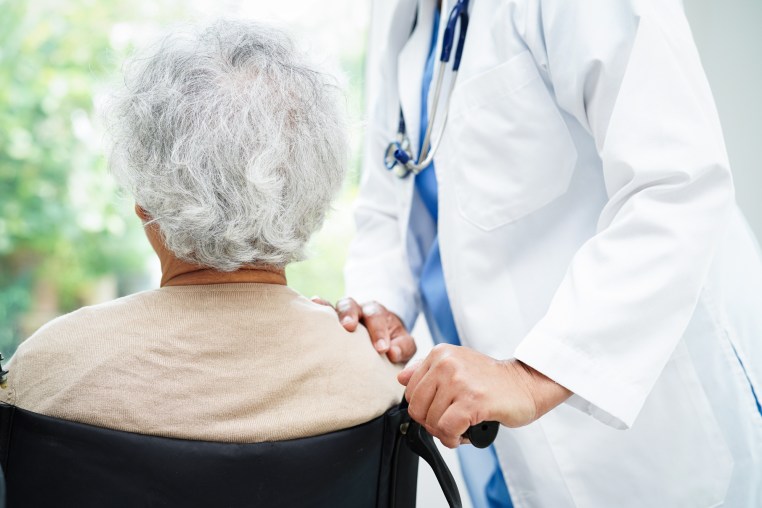 Doctor help Asian elderly woman disability patient in nursing hospital, medical concept.