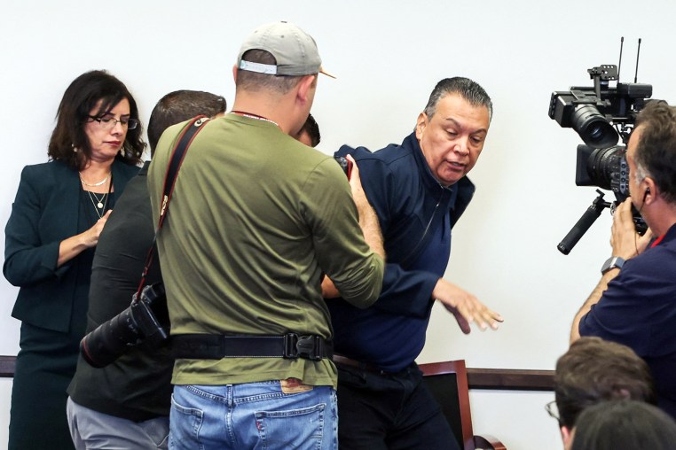 Sen.  Alex Padilla, D-Calif., is removed from the room during a news conference with Department of Homeland Security Secretary Kristi Noem in Los Angeles on June 12, 2025.