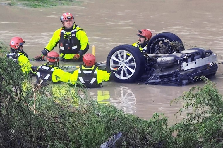 Responders in floodwater early Thursday morning June 12 in San Antonio.