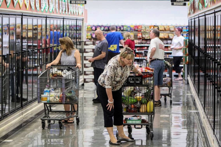 Shoppers browse the frozen food cases