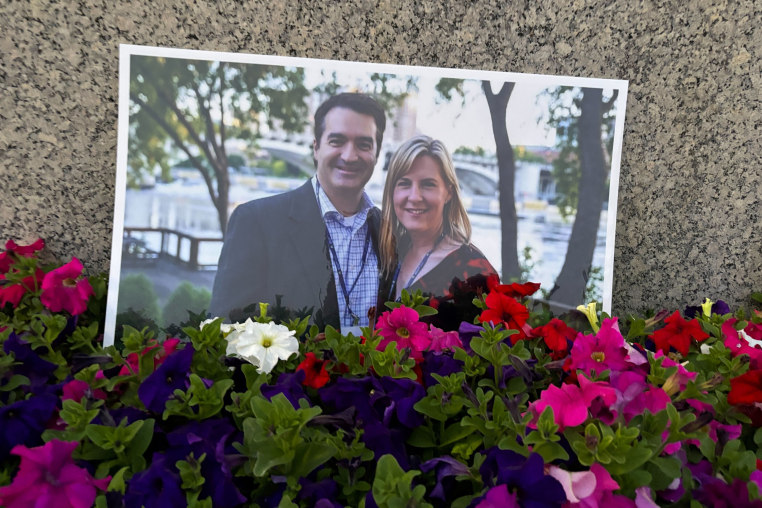 A photograph of Melissa Hortman and her husband amongst flowers
