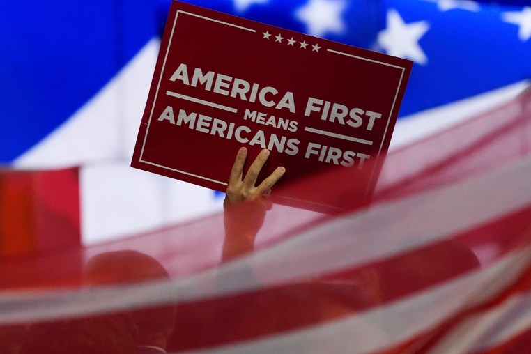A delegate waves an "America First" sign at the 2024 Republican National Convention in Milwaukee.