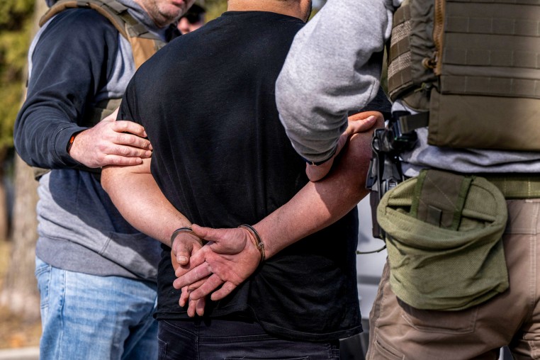 ICE agents carry out raid.
