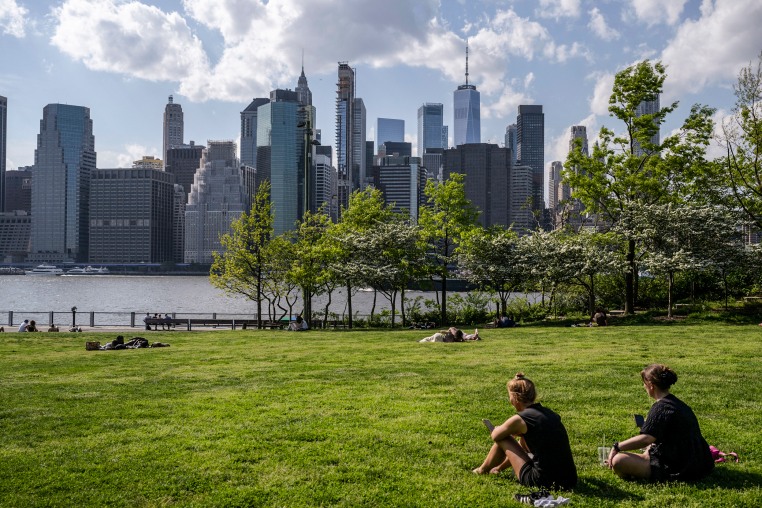 People sit in Brooklyn Bridge park