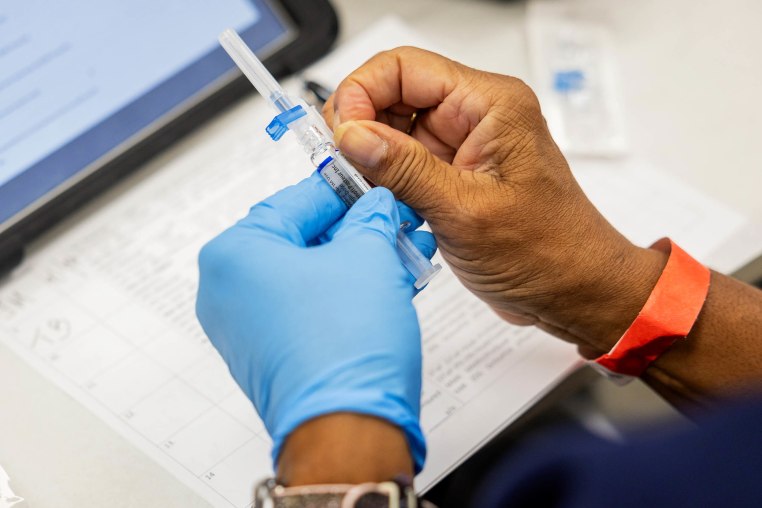 A photo of a nurse's hands as she prepares to administer a flu shot