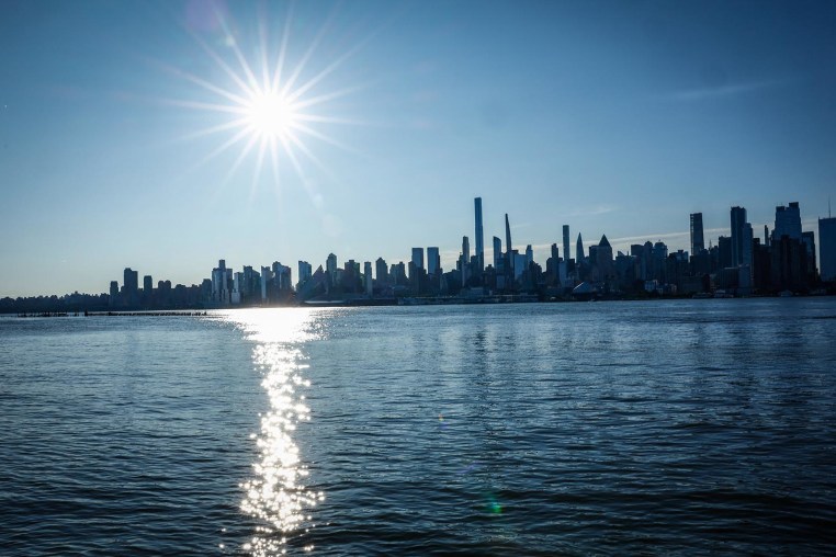 The sun rises over the New York skyline as seen from Weehawken N.J., on June 20, 2025.
