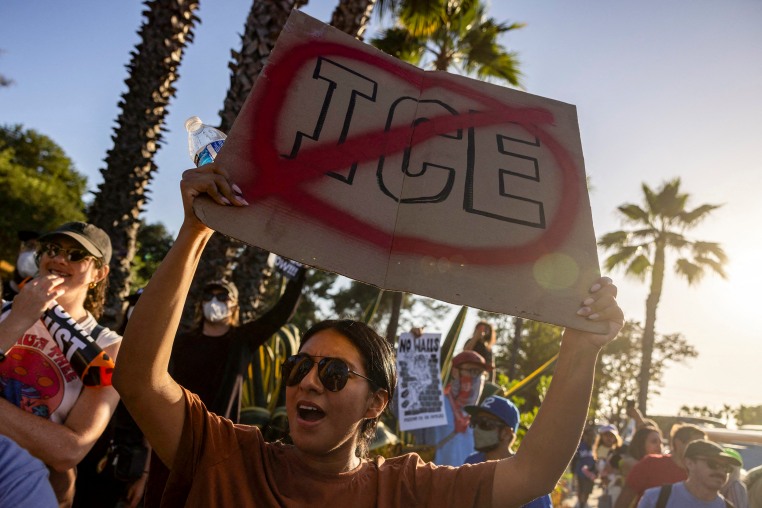 A person holds a sign in a protest.