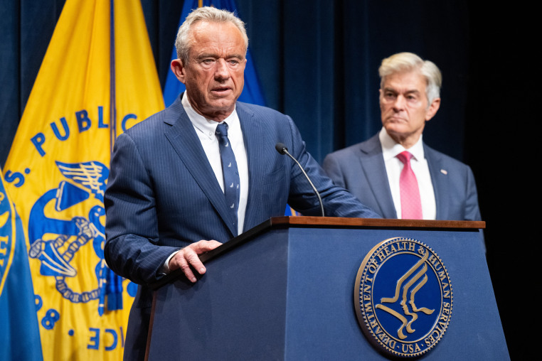 Image: Medicare and Medicaid Administrator Mehmet Oz, right, listens to Secretary of Health and Human Services Robert F. Kennedy Jr. speak