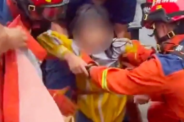 A little girl in China is rescued from a storm drain after intense flash flooding.