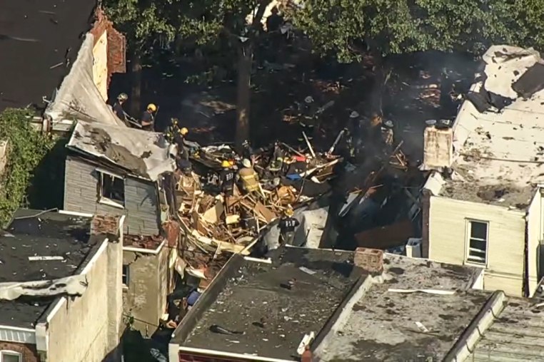 Firefighters at the site of a collapsed home, aerial view