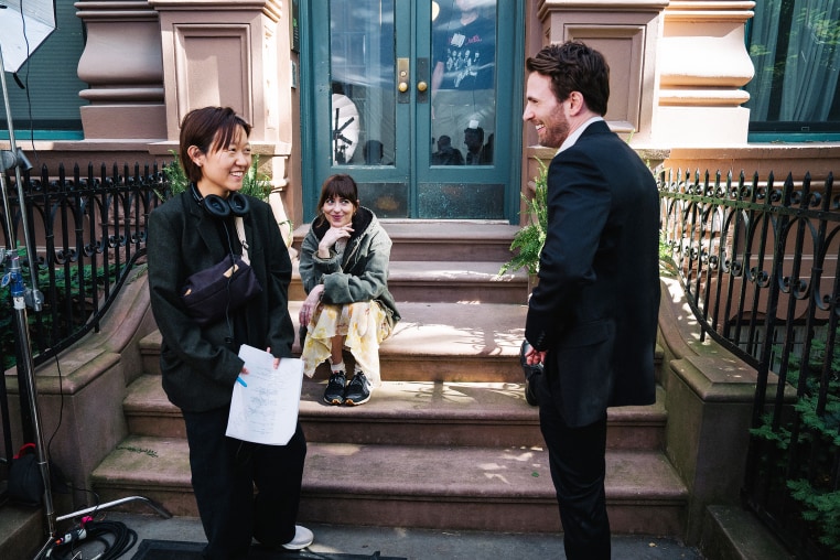Celine Song on set with Dakota Johnson and Chris Evans.
