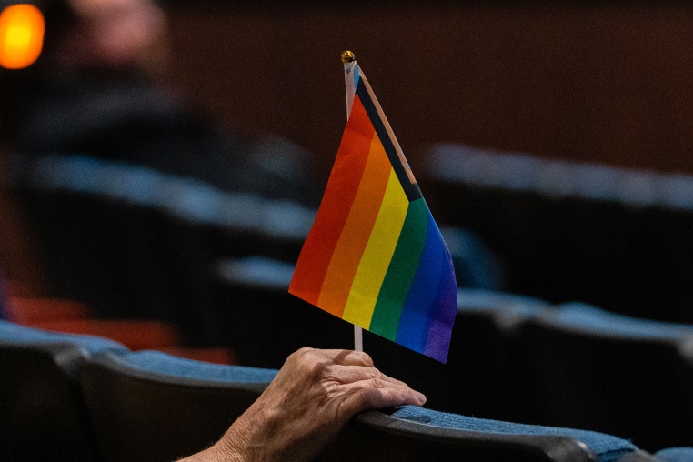 A person holds an inclusive pride flag during a Fairfax County School Board meeting after a rally in support of inclusive Family Life Education at Luther Jackson Middle School in Falls Church, Va. on July 14, 2022. 
