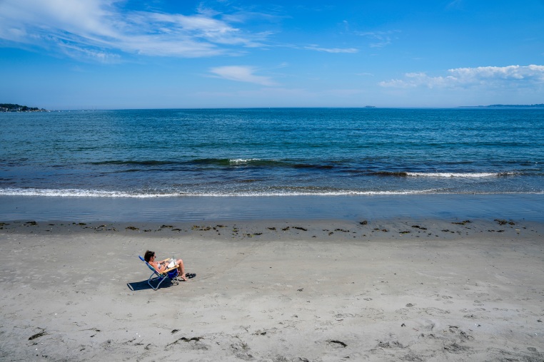 A person sits on the beach.