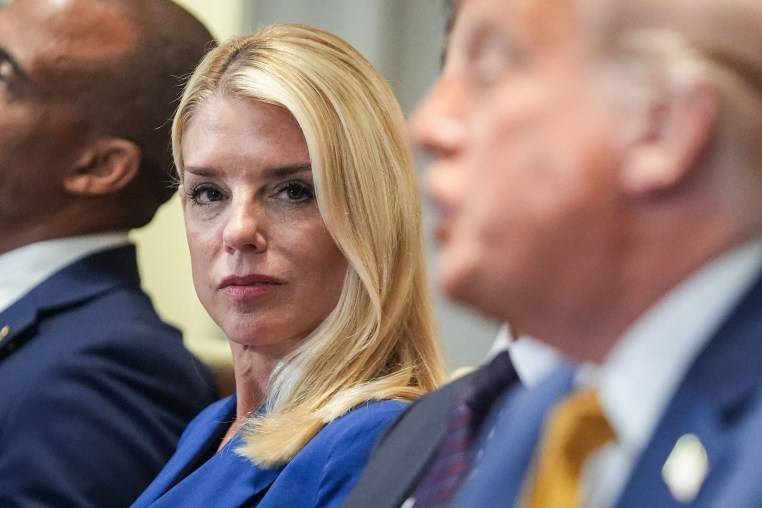 Pam Bondi, left, listens as President Donald Trump speaks
