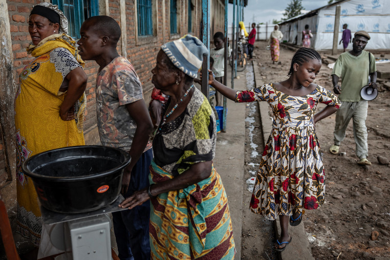 Refugees waiting in line for food.