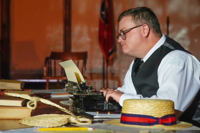 Anthony Smith sits with a typewriter 