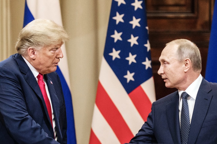 President Donald Trump and Russian President Vladimir Putin shae hands