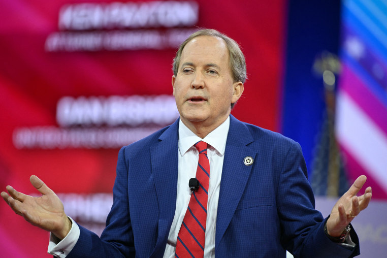 Ken Paxton gestures while speaking.