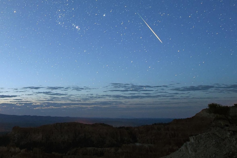 A meteor streaks across the sky over Bryce Canyon National Park in Utah during the annual Perseid meteor shower.