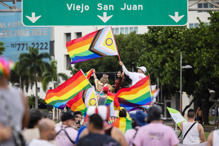 Participants waves pride flags on their way to Old San Juan.