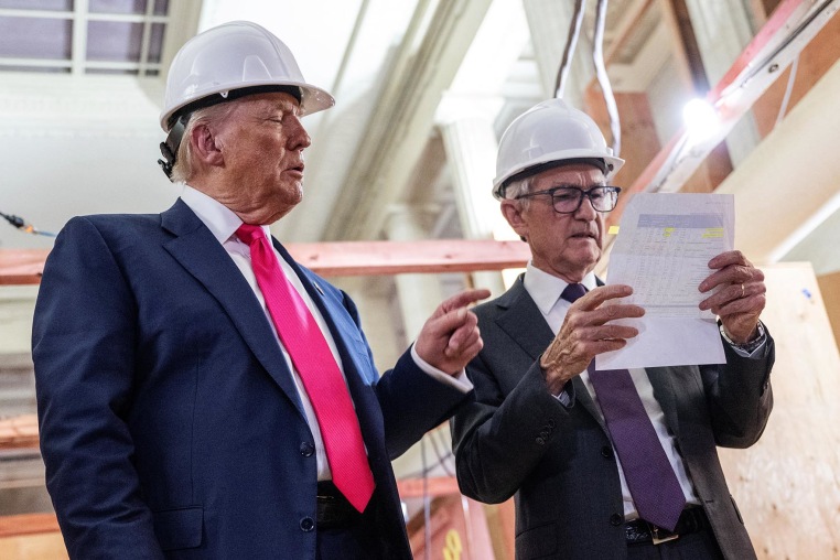 President Donald Trump points to a cost sheet as he speaks with Federal Reserve chair Jerome Powell at the Federal Reserve in Washington on July 24, 2025. 