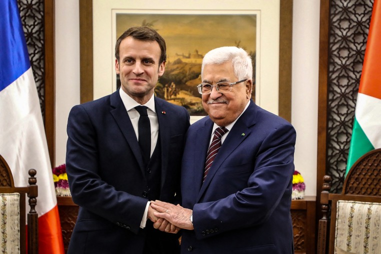 Image: French President Emmanuel Macron shakes hands with Palestinian President Mahmoud Abbas