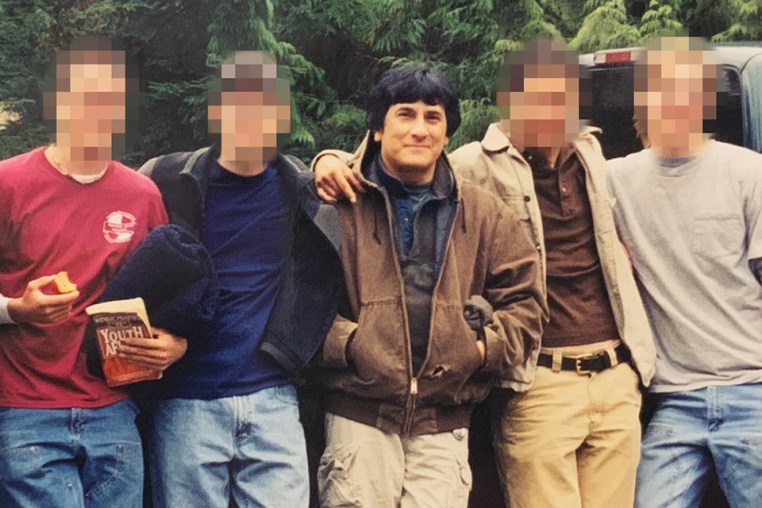 Savala poses with Eli Stewart and other young followers in Alaska in 2002.