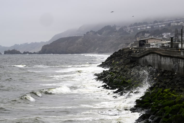 The Pacific Ocean along coastline as a wave crashes onto the land