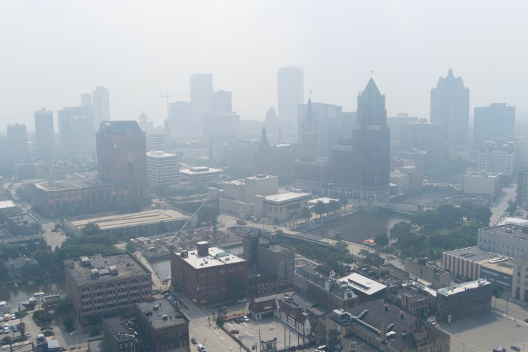 Aerial view of a blanket of smoke filling the air above buildings