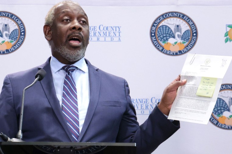 Jerry Demings holds up a copy of the letter