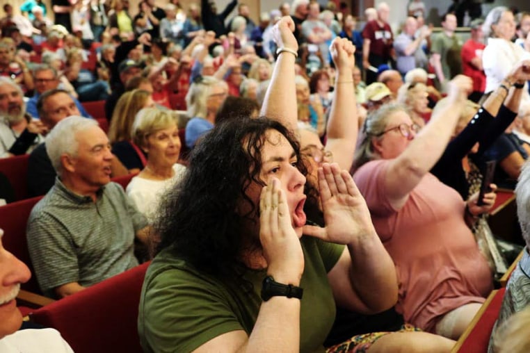 The crowd reacts as Rep. Mike Flood, R-Neb., answers questions from constituents during a town hall in Lincoln on Aug. 4, 2025. 